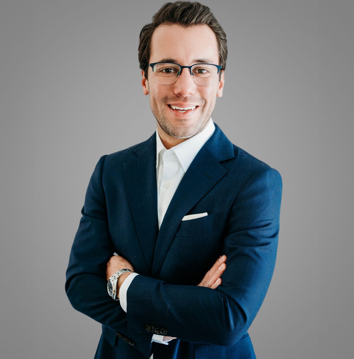 Professional man in suit smiling confidently.