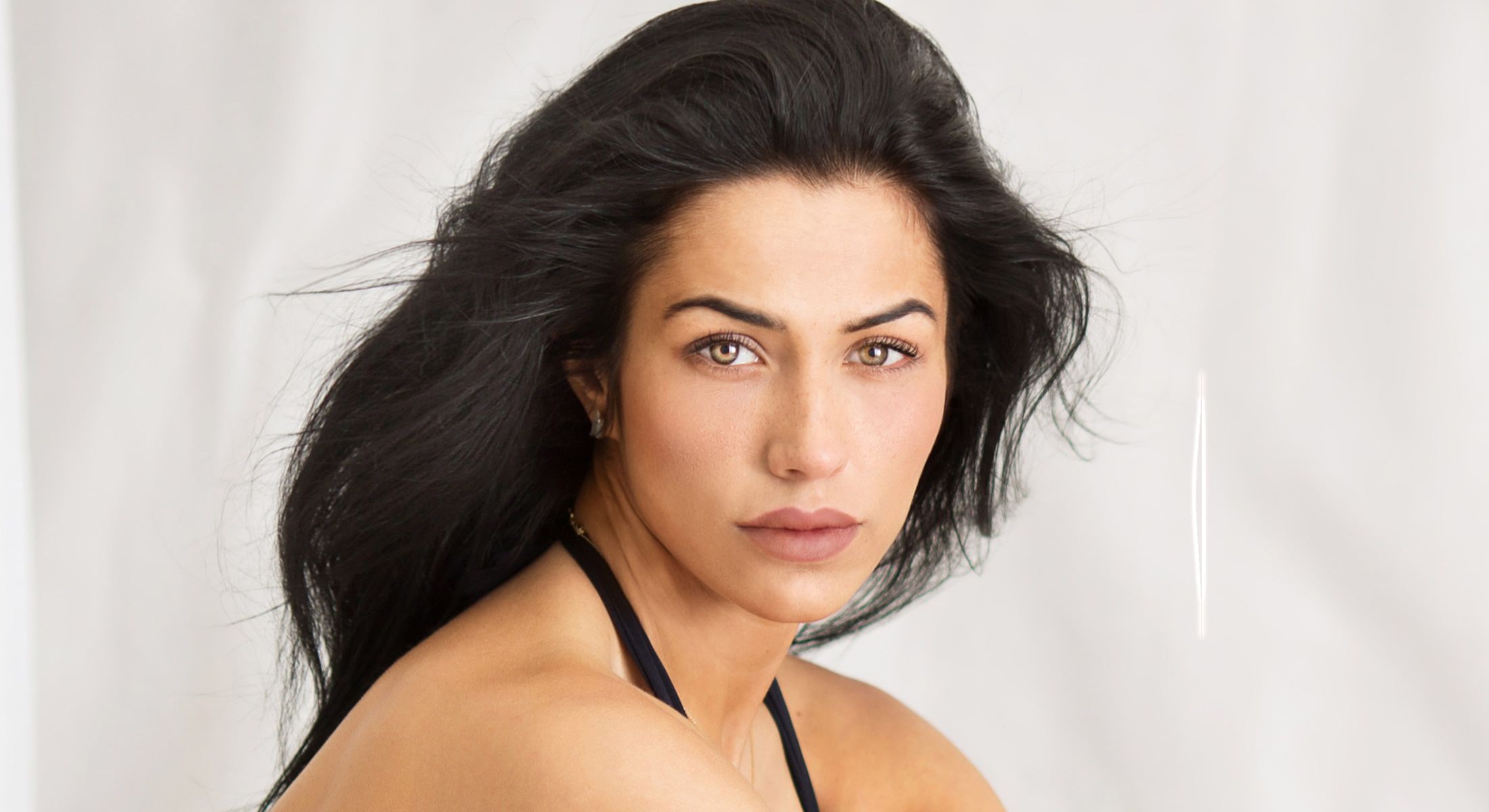 Portrait of a woman with flowing dark hair.