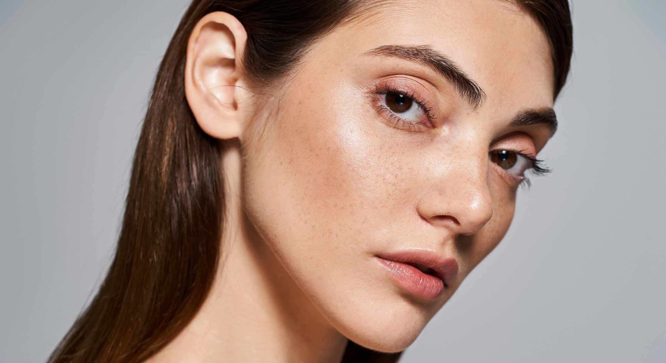 Close-up of a woman's face with freckles.