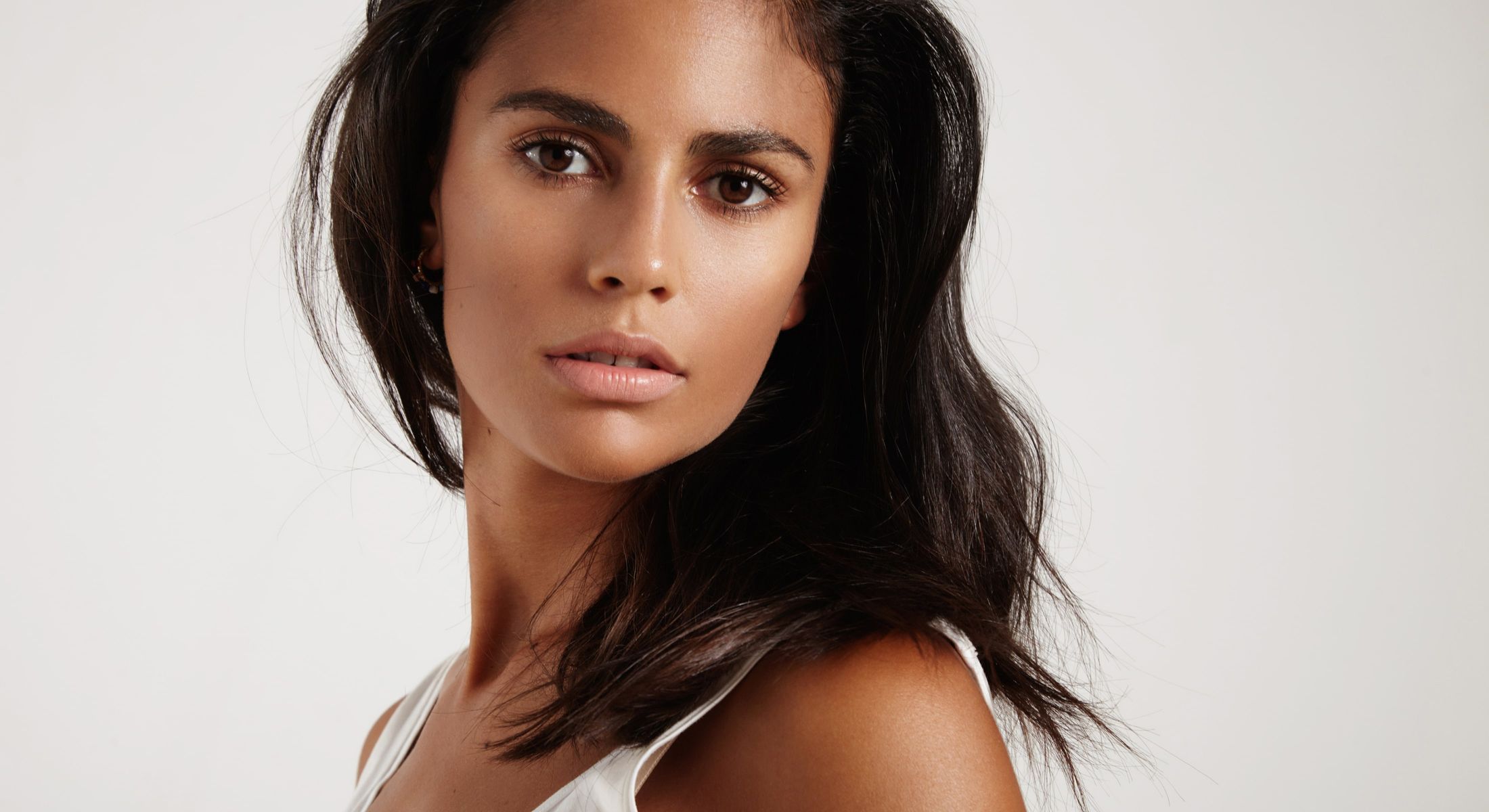 Close-up of a woman with long dark hair.