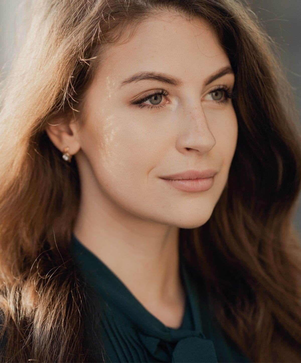 Young woman with long hair and green eyes.