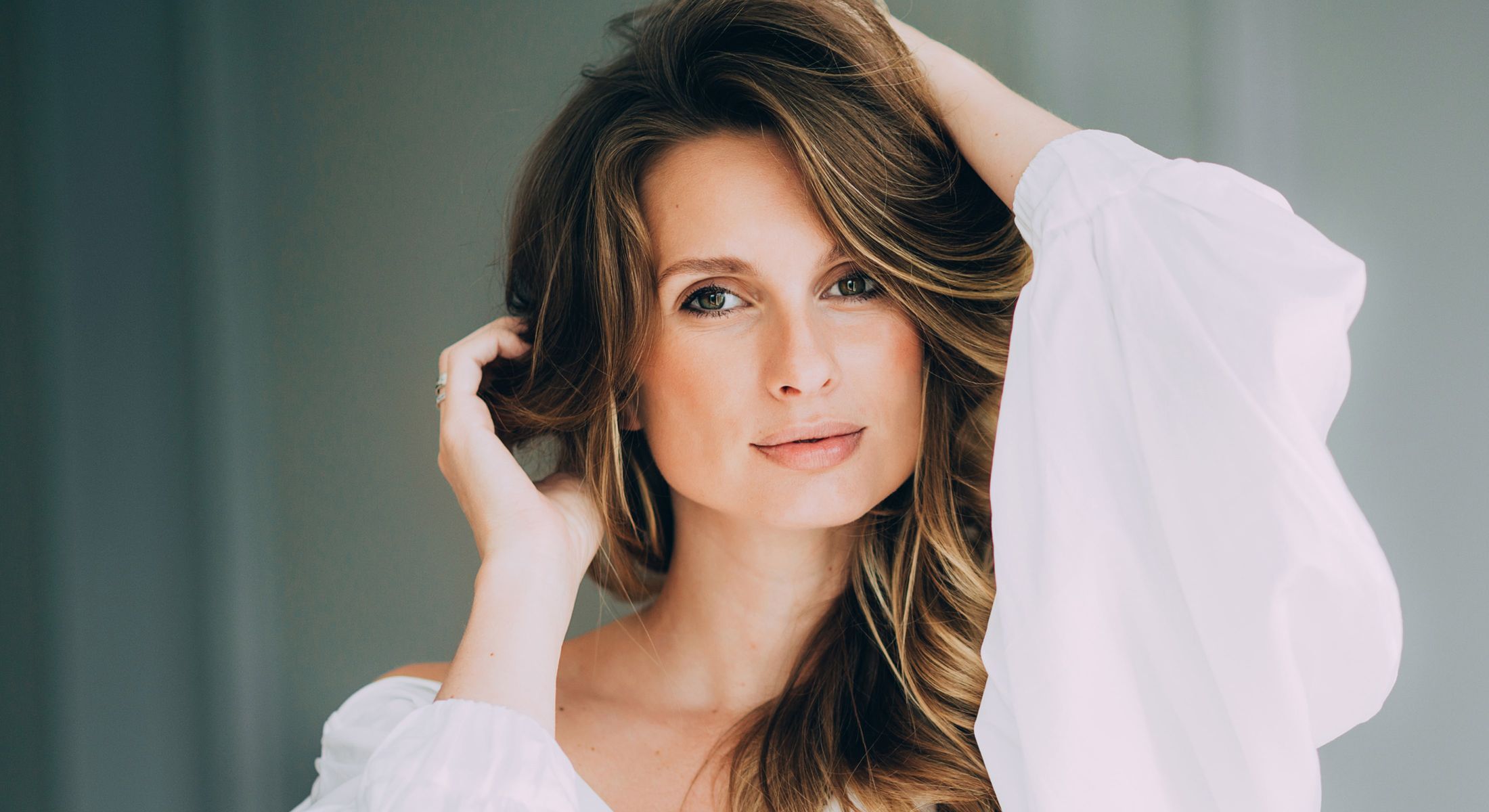 Woman with long hair in white blouse.