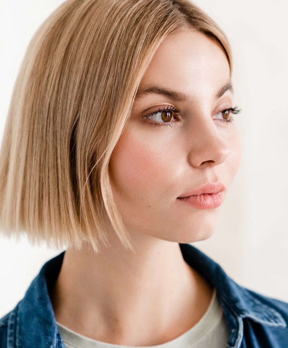 Woman with a short bob hairstyle and expressive gaze.