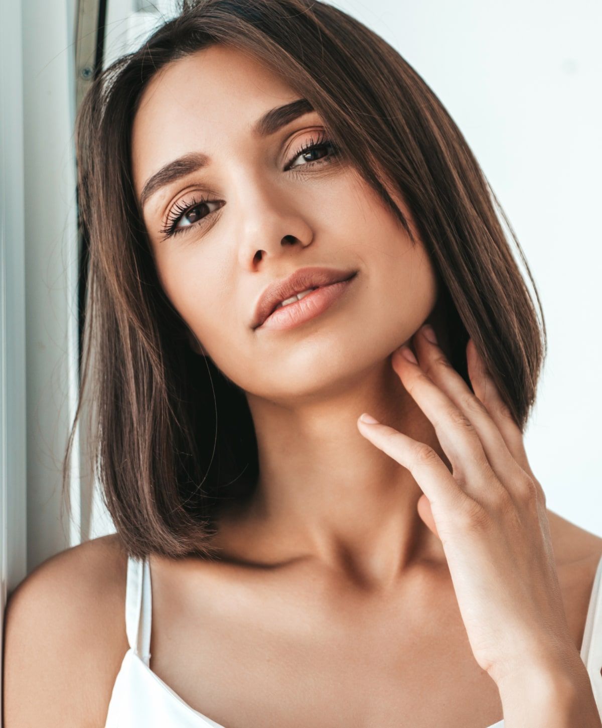 Woman with natural makeup and short hair.