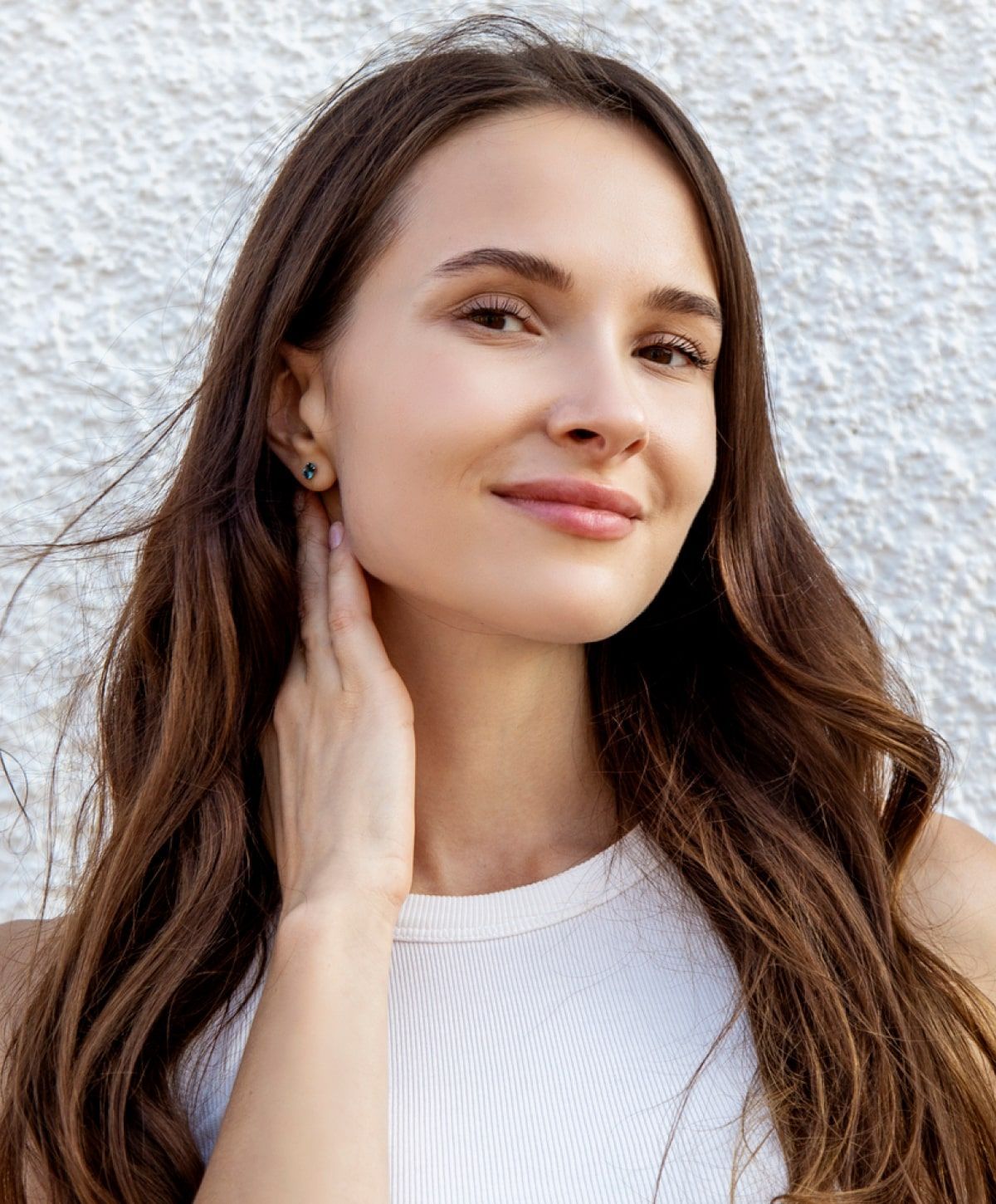 Young woman smiling with long brown hair.