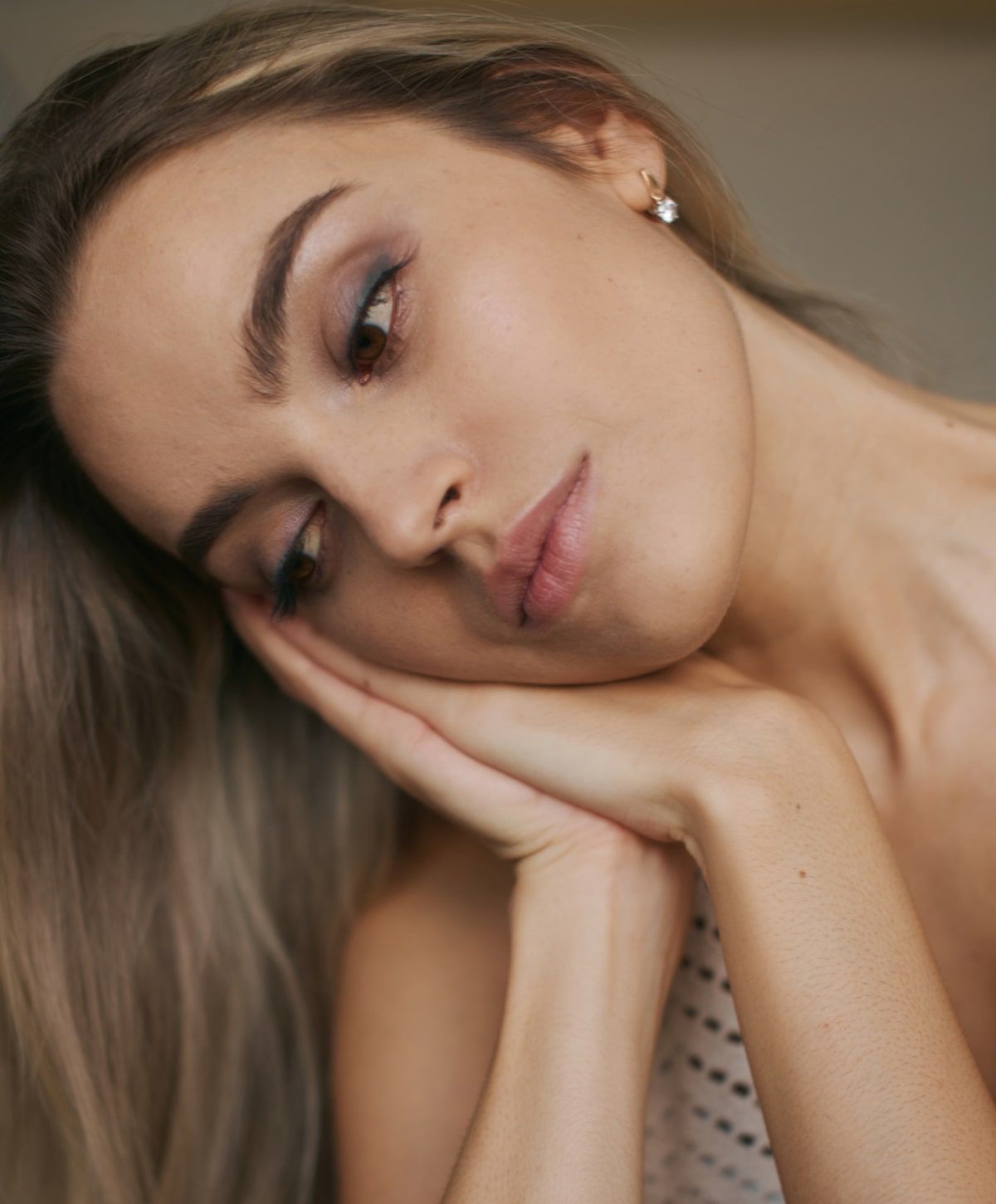 Woman resting her head on her hands.