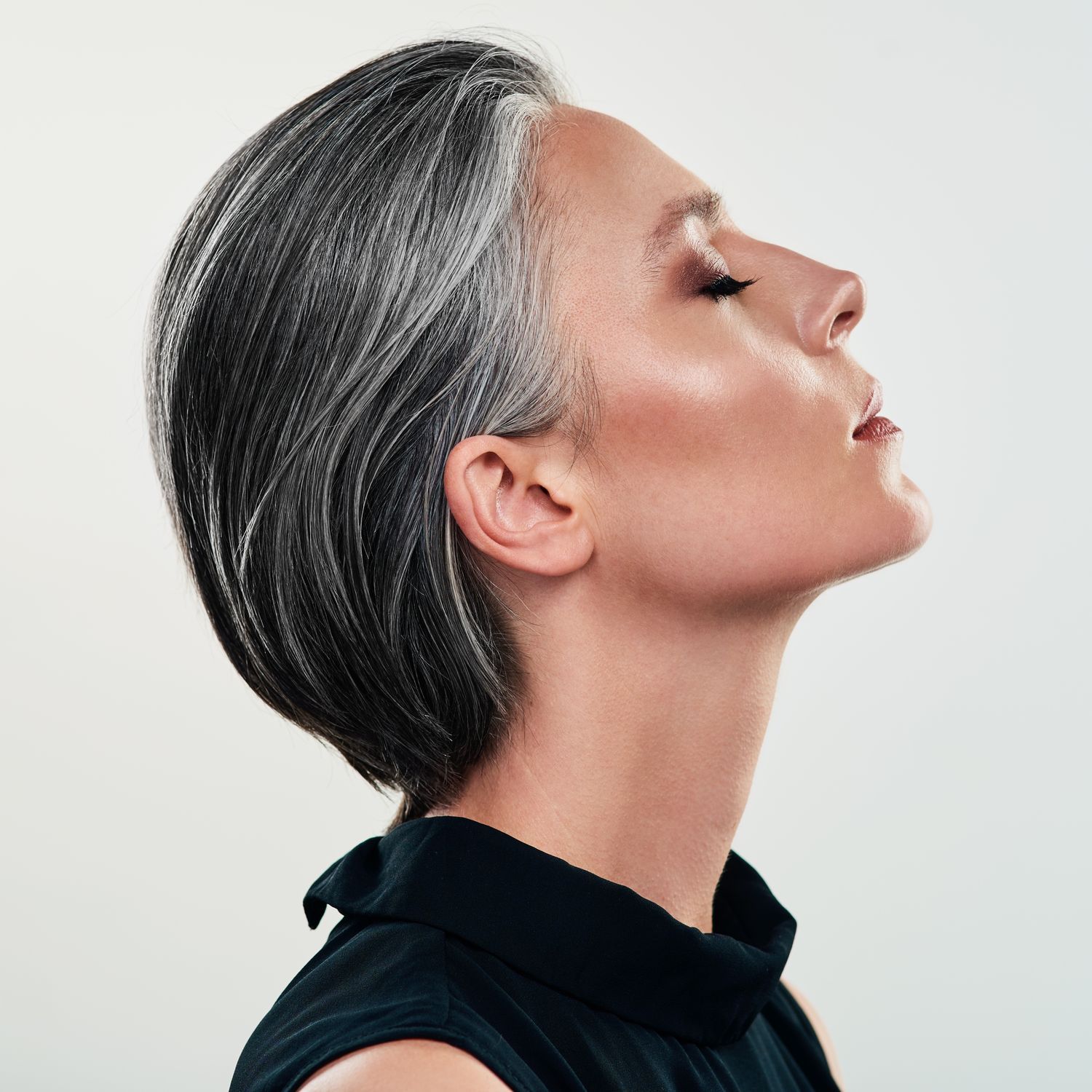 Profile of a woman with short gray hair.