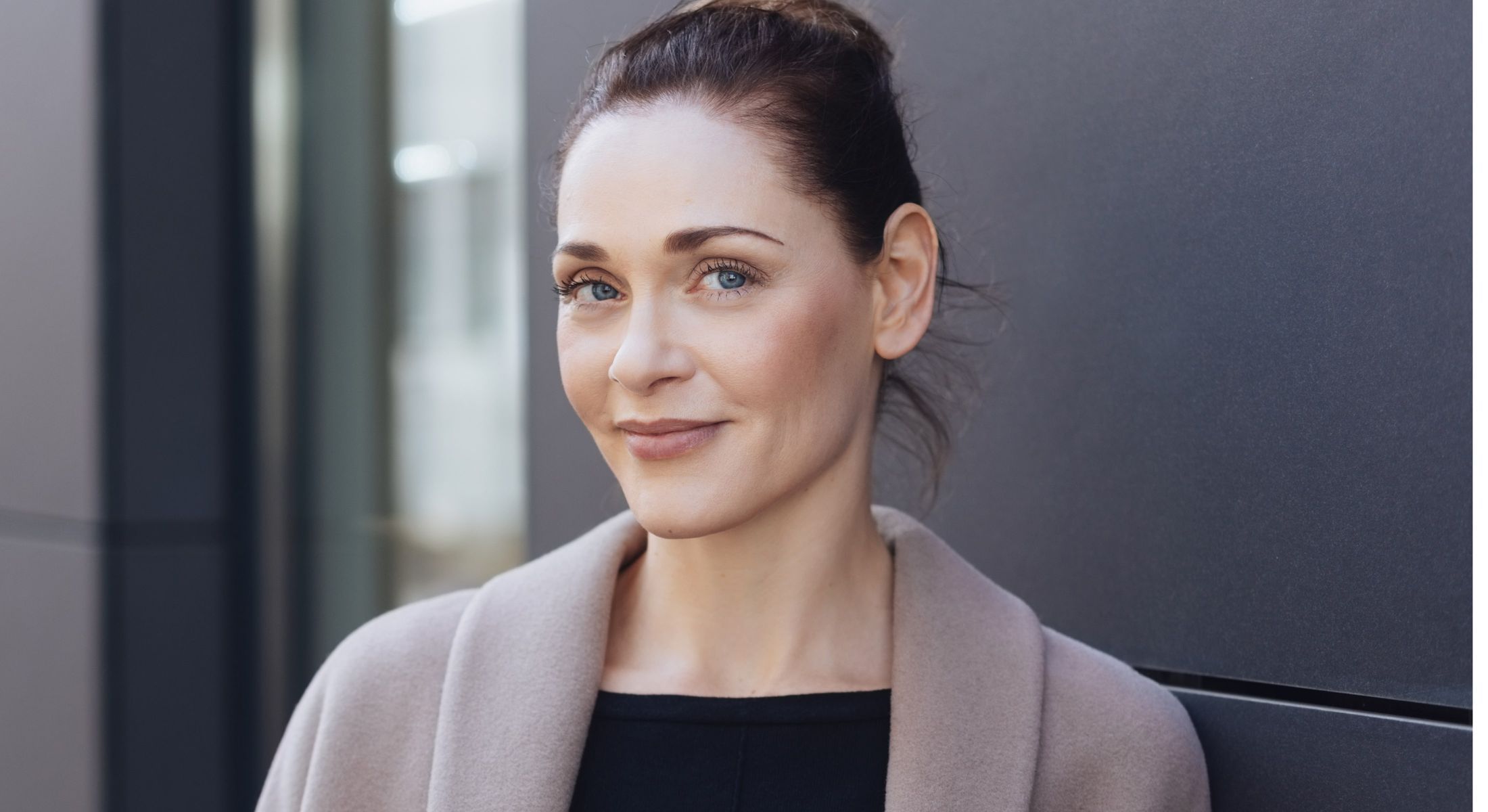 Smiling woman in casual outdoor setting.