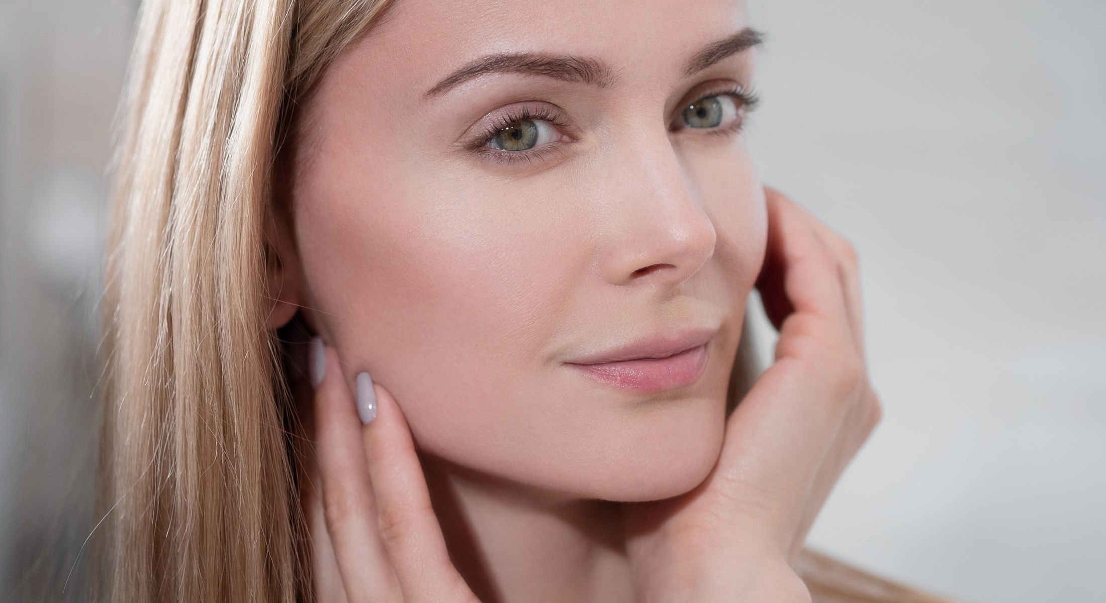 Woman with glowing skin and soft facial features.